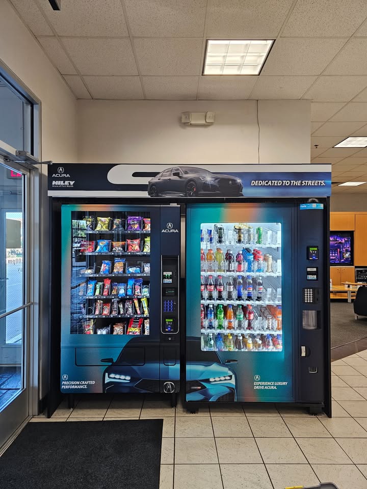Custom branded snack and beverage machines in a business showroom